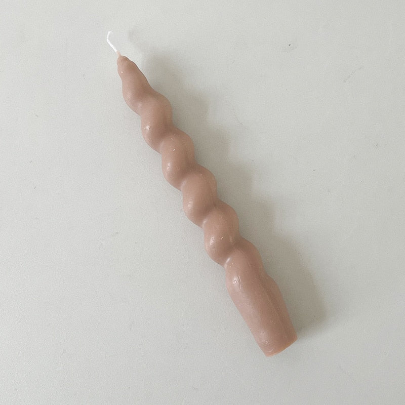 Single twisted pillar candle with a nude colour.