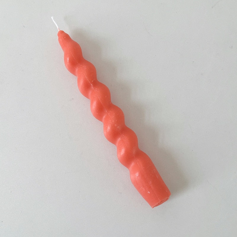 Single twisted pillar candle with a rich orange colour.