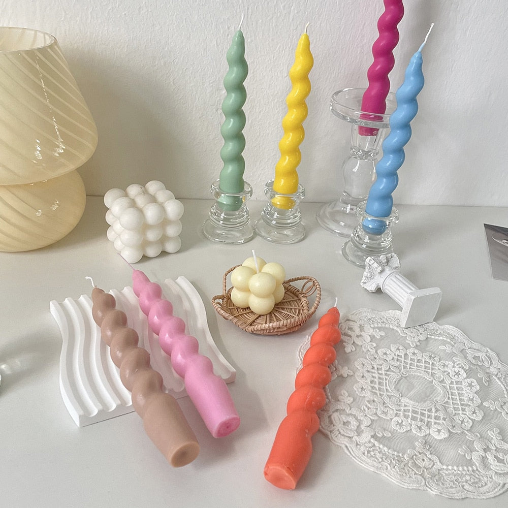 Vibrant assortment of tapered candles in various hues, adding a pop of colour to any setting