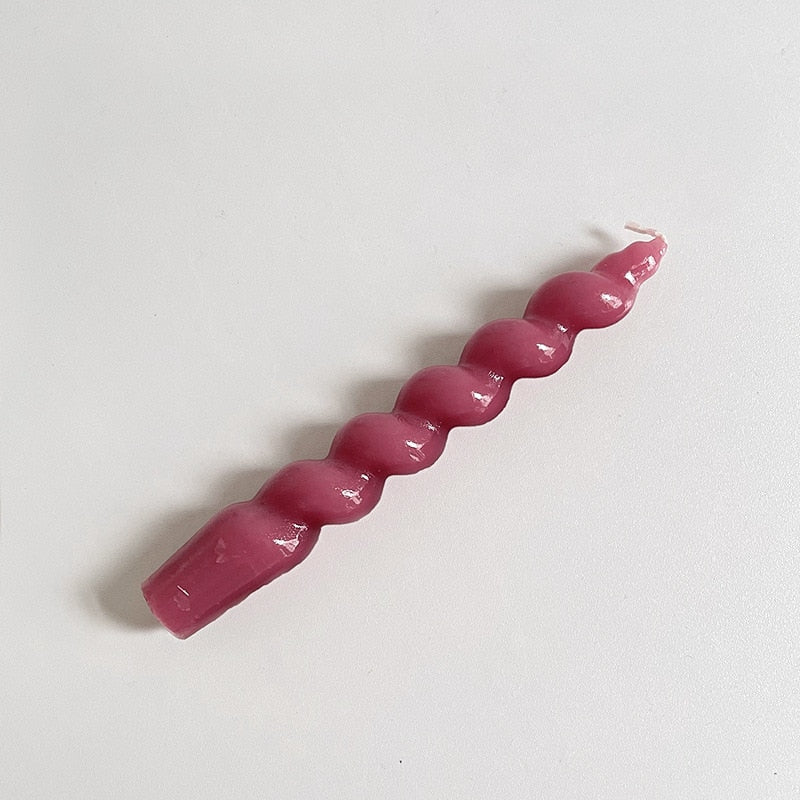 Single twisted pillar candle with a rich plum colour.