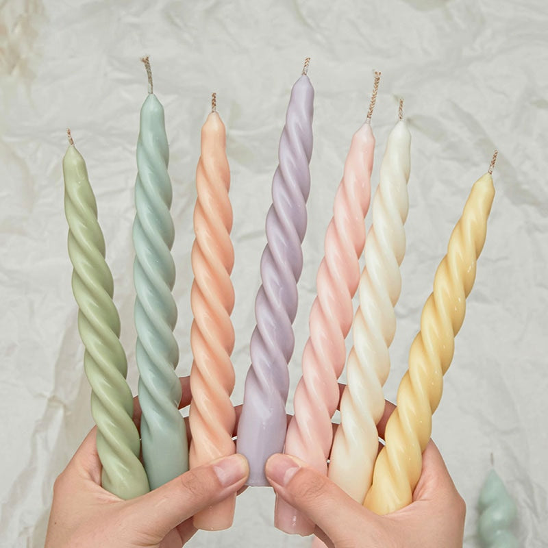 Vibrant assortment of tapered candles in various hues, adding a pop of colour to any setting.